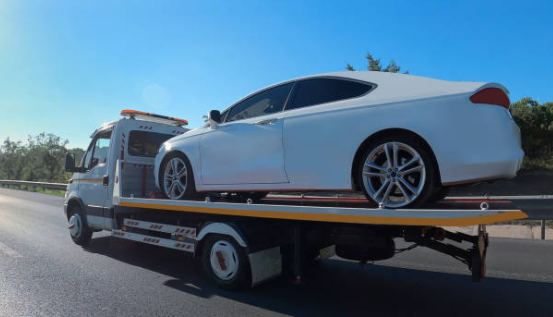 Flatbed truck safely transporting a car in the UK