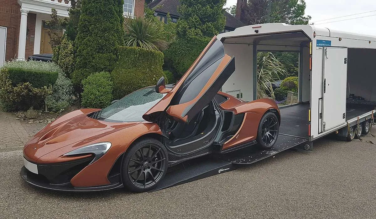 Car being loaded onto a flatbed truck in the UK